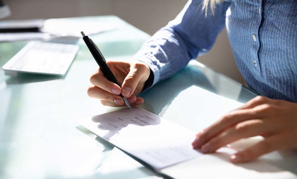 Woman writing a check