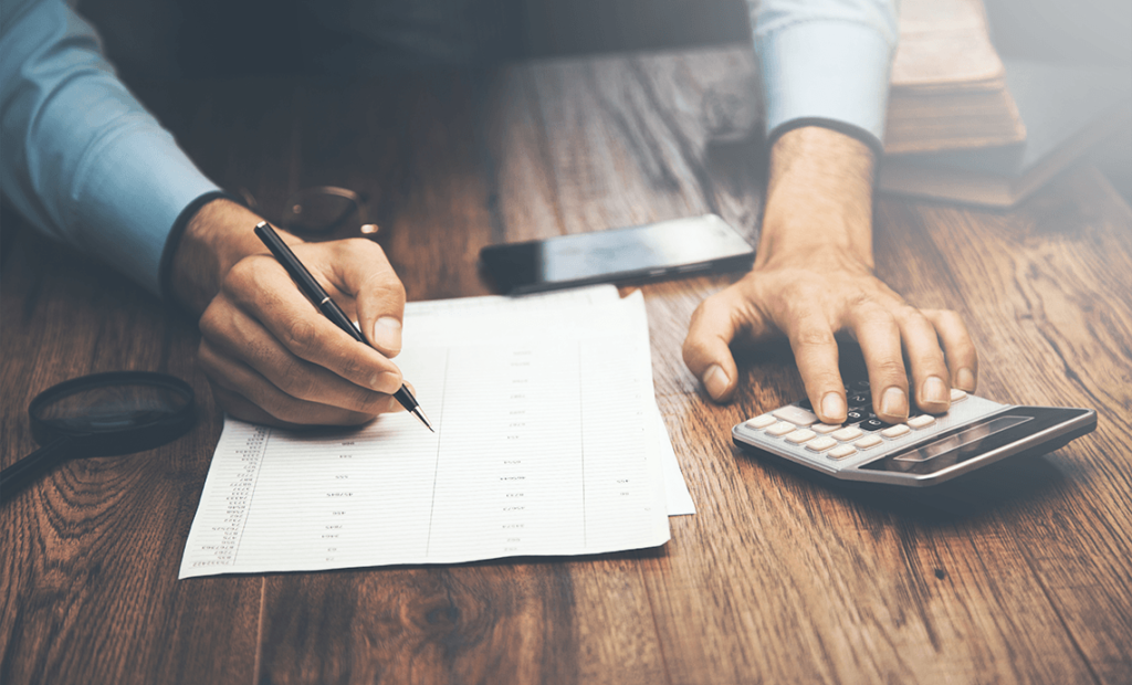 Man with spreadsheet and calculator