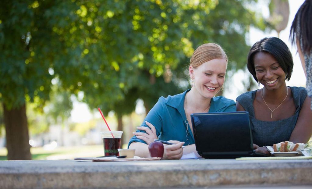 Two businesswomen looking at a laptop