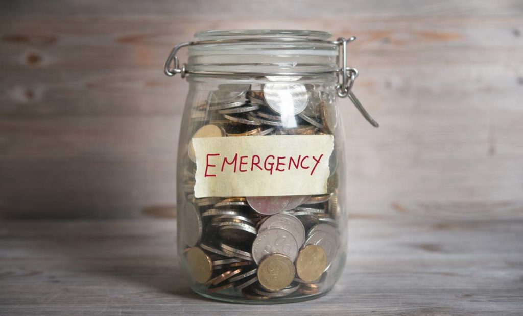 A jar full of coins labeled emergency
